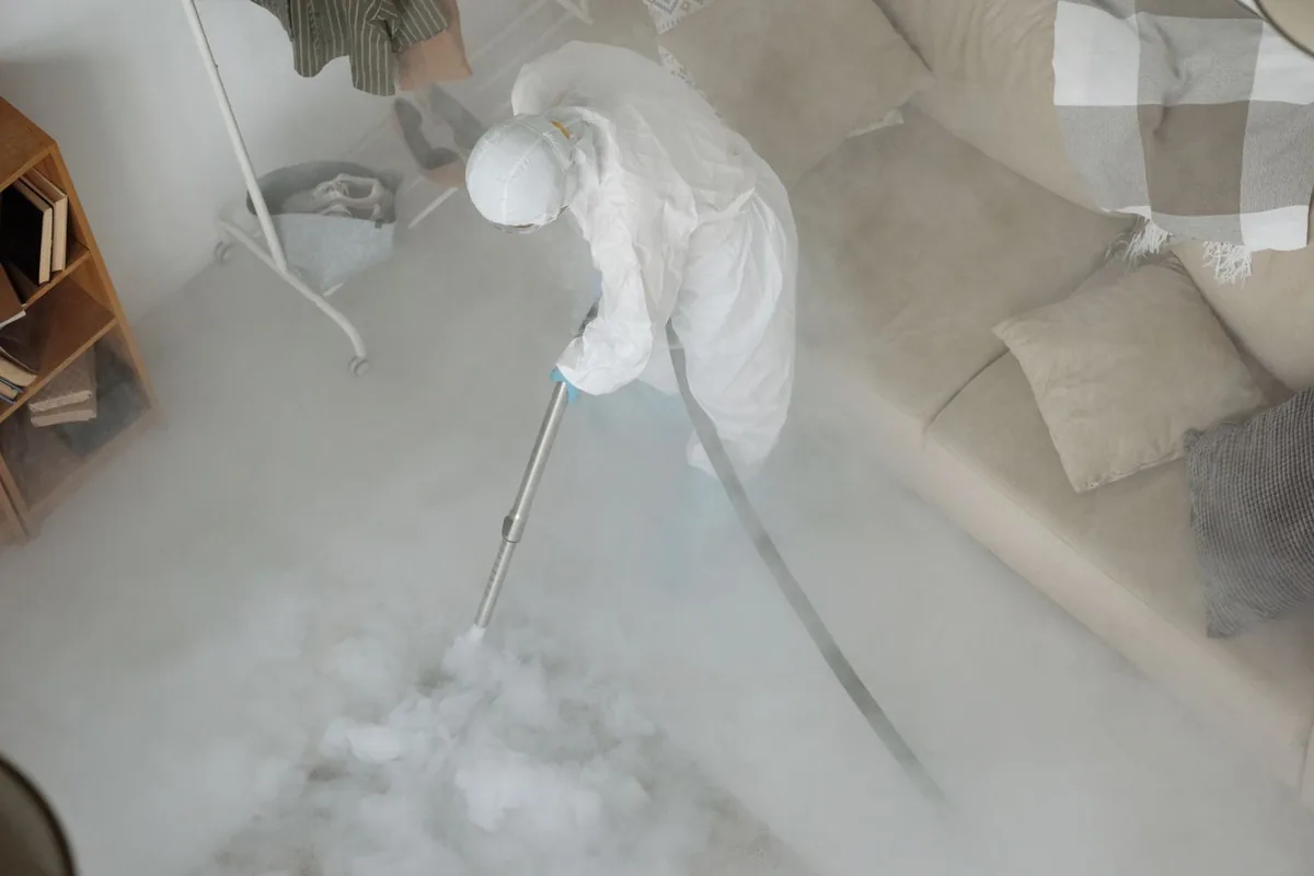 Biohazard cleanup technician in protective equipment, Rio Vista, TX